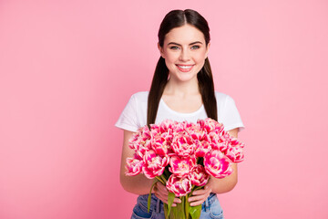 Close-up portrait of her she nice attractive lovely pretty charming cheerful cheery girl holding in hands flowers shop boutique store isolated over pink pastel color background
