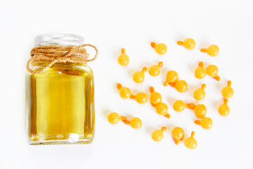 natural mint oil in a bottle and medicinal capsules