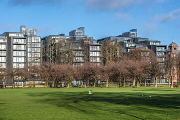 Residential buildings in Quartermile area seen from Meadows park in Edinburgh, UK