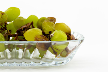 Rotten green grapes on white backgroung
