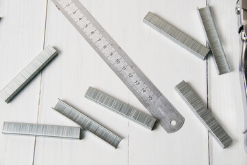 Construction brackets and ruler on a light wooden background with copy space. The concept of...