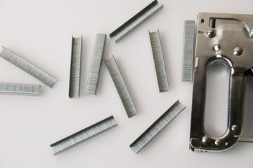 Construction stapler and staples on a light background with copy space. The concept of...