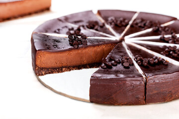Cheesecake topped iwth chocolate and nuts.