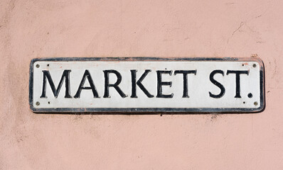 Street sign on wall saying Market Street located in Market St, Newport, Pembrokeshire. Wales. UK