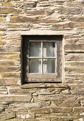 Old square window frame and stone wall in building in Felindre Farchog, near Newport. Pembrokeshire, Wales. UK