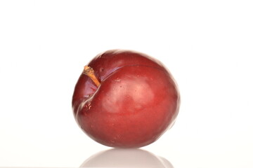 Juicy, tasty, organic red plum, close-up, on a white background.