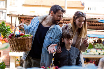 Beautiful family of three buying groceries