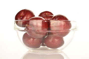 Juicy, tasty, organic red plum, close-up, on a white background.