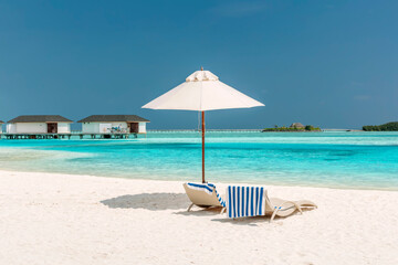 Chaise-longues with the striped towels on the beach somewhere in Maldives.