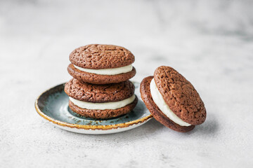 Chocolate whoopie pies on gray background with copy space. © Alina
