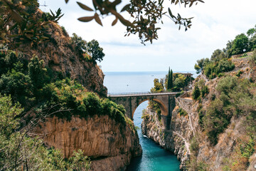 Architectural landmark, stone bridge. A view of the Fiordo of Furore in Amalfi coast, Travel and vacation concept. Summer day. public beach closed. Copy space. Italy.
