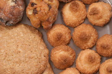 Cakes assort on a ceramic plate, close up