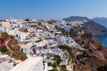 Beautiful view of fabulous picturesque village of Oia with traditional white houses and windmills in Santorini island, Greece