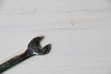 Wrench on wooden background with copy space.
