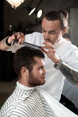 Fototapeta premium Men's hairstyling and haircutting in a barber shop or hair salon.