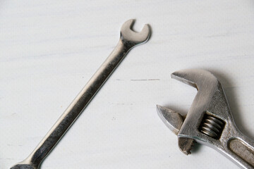 Two vintage wrenches, adjustable spanners and spanners, on a light wooden background