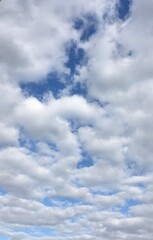 Blue sky with rolling white clouds