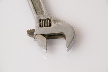 Old, vintage adjustable spanner wrench isolate on a white background