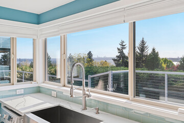 Fototapeta na wymiar White modern kitchen interior with amazing view from the windows