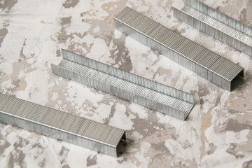 Concept of repair and construction. Construction brackets on a gray decorative putty background, copy space, macro closeup