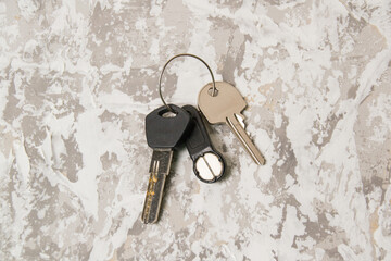 Keys to the apartment or house, intercom key on a light wooden background.