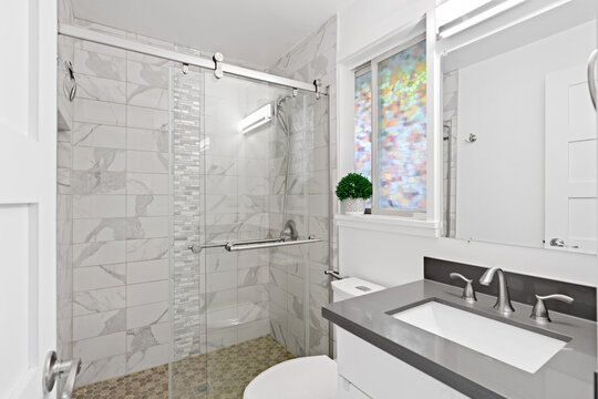Stylish white bathroom interior with marble shower
