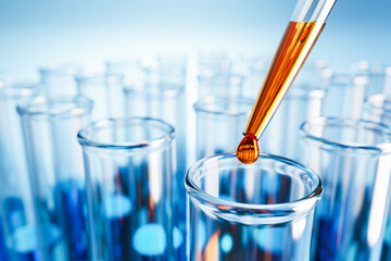 Closeup of test tubes with orange or blue liquid. Dropping glass with an orange drop above. Testing...