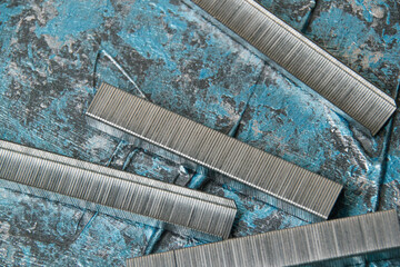 Concept of repair and construction. Construction brackets on a background of blue decorative putty...