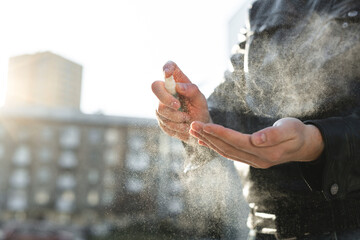 Disinfection of the hands. A person using an antiseptic spray on their hands to prevent a coronavirus or flu disease. Personal hygiene. Coronavirus. Covid 19