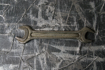 Old wrench on a dark gray background with copy space
