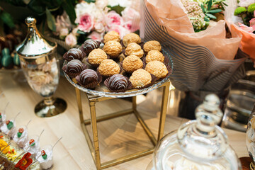 Delicious sweets on candy buffet. Candy bar on wedding ceremony with a lot of different candies.