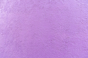 purple - violet colour on the abstract random texture curve cement on the wall at afternoon time.
