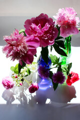 Bouquets of multi-colored wild flowers on a white background, vertical view. Colorful flowers background.