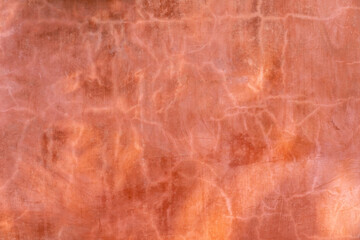 cracked and smudges red orange cement wall that random pattern from sunlight burn action.