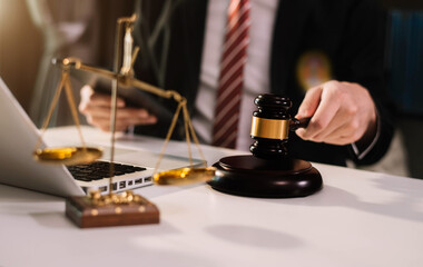 Lawyer office. gavel of Justice with scales and lawyer working on a laptop. Legal law, advice and justice concept.