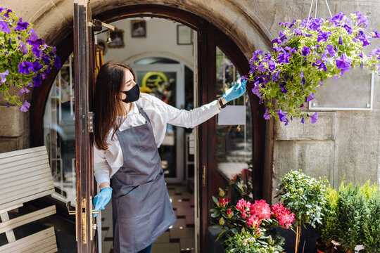 Coronavirus Covid 19. Floral Shop Woman Owner With Face Mask, Open After Lockdown Quarantine. End Quarantine. Announcement We Are Open Nv Doors, Flower Shops, Cafes,coffee Houses.