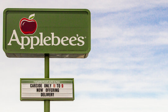 Birch Run, Michigan, USA - June 3, 2020: Sign for Applebee's restaurant with limited hours and offering take out only due to Coronavirus stay at home order in Michigan. 