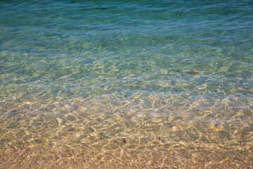 Close up shout of clear, mildly wavy sea on a summer day