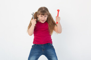 a beautiful girl is laughing and holding a toy hammer and wrench and on a white background