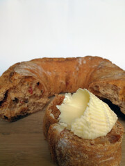 fresh tasty crispy delicious bread with butter on a wooden plate