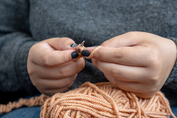 Women's hands knit from color wool. Hand knitting