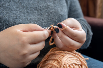 Women's hands knit from color wool. Hand knitting