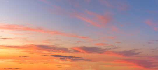 panorama of a blue-pink sunset with clouds of pink hues. sunset on the horizon. photo for the banner. space for text.