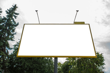 big billboard on a background of sky and trees. White background for replacement. MOCKUP.