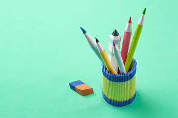 Fototapeta premium Multicolored paper pencils in decorative glass