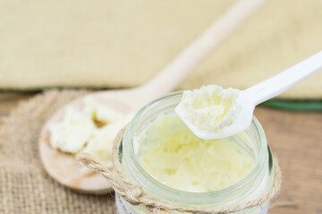 Shea butter in jar and on the spoon