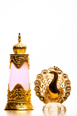 glass perfume bottle gold peacock white background 