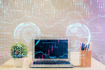Double exposure of chart and financial info and work space with computer background. Concept of...