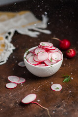 Sliced Radishes on dark background.
