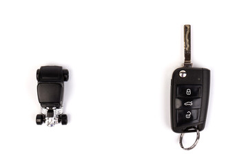 Modern folding car key and toy car isolated on white background